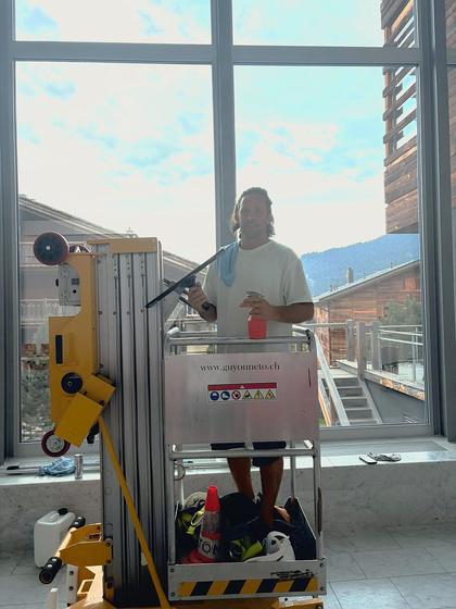 Cleaning interior glass from a powered access platform.